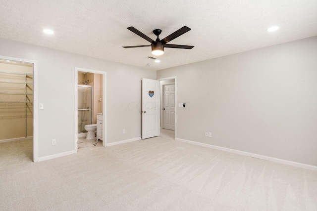 5595 Marshfield Dr, Westerville, OH 43081 - unfurnished bedroom featuring a walk in closet, light carpet, recessed lighting, ensuite bath, and a ceiling fan