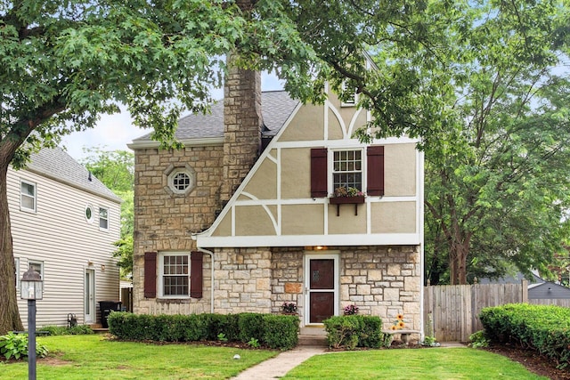 208 S Stanwood Rd, Bexley, OH 43209 - tudor home with stone siding, stucco siding, a shingled roof, and a chimney