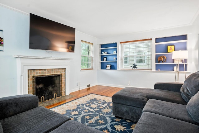 208 S Stanwood Rd, Bexley, OH 43209 - living area with built in features, wood finished floors, crown molding, and a fireplace