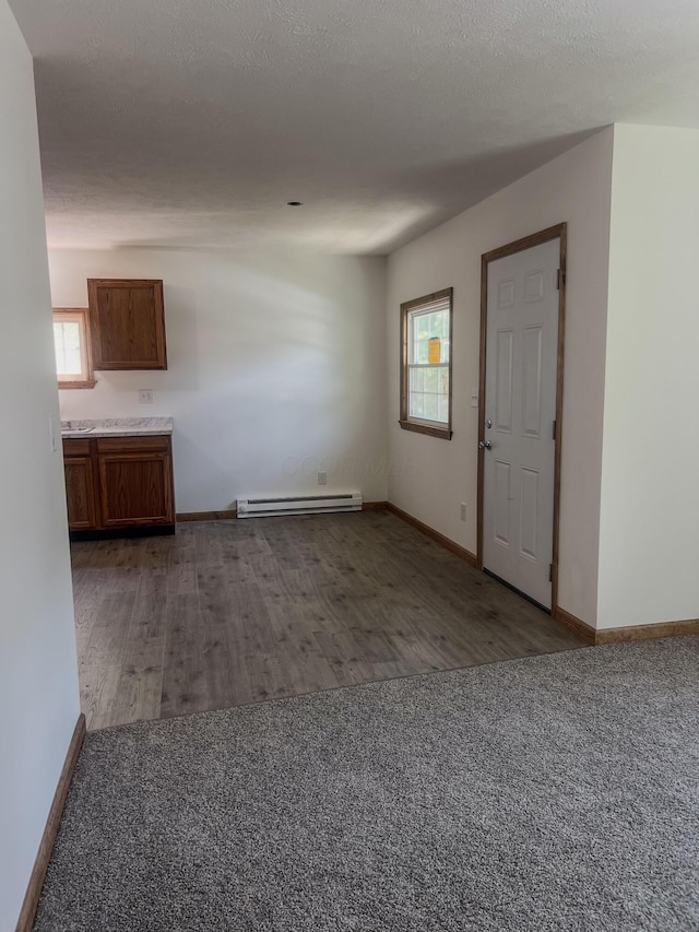 623 Glencroft Ave, Chillicothe, OH 45601 - unfurnished living room with a baseboard heating unit, plenty of natural light, and carpet