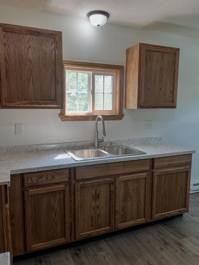 623 Glencroft Ave, Chillicothe, OH 45601 - kitchen featuring dark wood finished floors, light countertops, and a baseboard heating unit