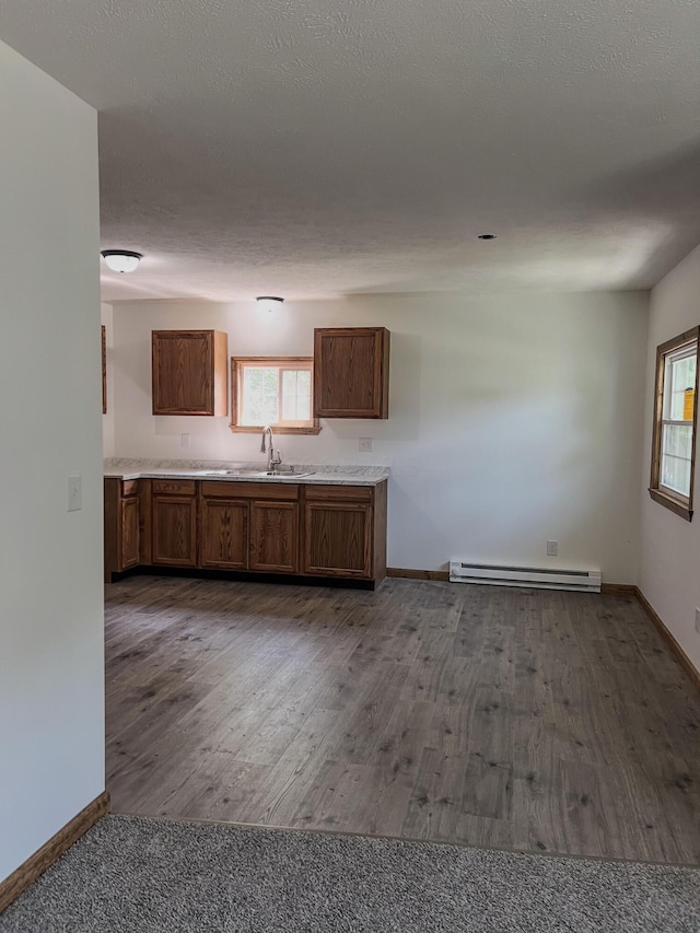 623 Glencroft Ave, Chillicothe, OH 45601 - kitchen with a baseboard radiator, brown cabinets, dark wood-type flooring, and light countertops