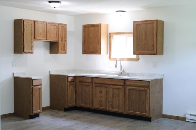 623 Glencroft Ave, Chillicothe, OH 45601 - kitchen with brown cabinets, light wood-style floors, a baseboard radiator, and light countertops