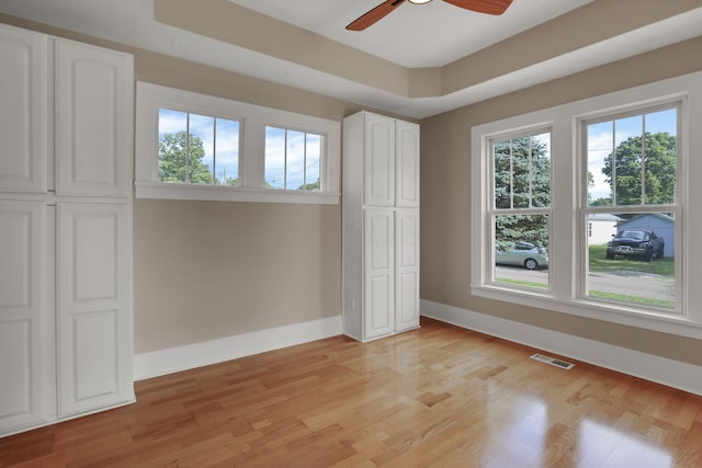 156 E Postal Ave, Newark, OH 43055 - unfurnished bedroom with multiple windows, light wood-type flooring, and a ceiling fan
