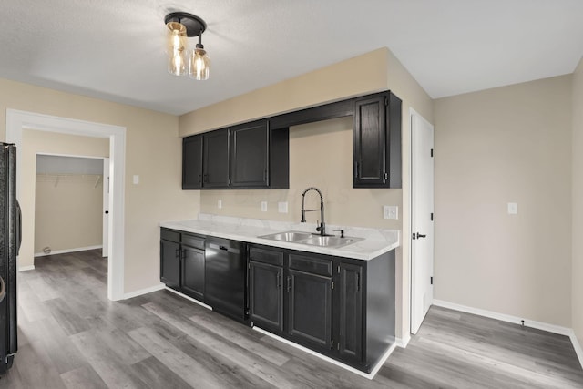 156 E Postal Ave, Newark, OH 43055 - kitchen featuring dishwashing machine, dark cabinetry, wood finished floors, and light countertops