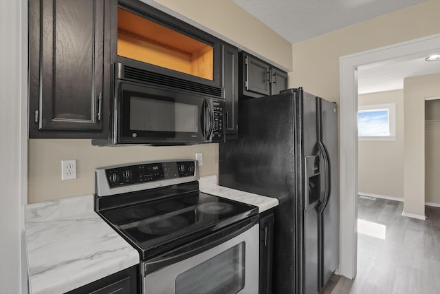 156 E Postal Ave, Newark, OH 43055 - kitchen with black appliances, light wood finished floors, and light stone counters