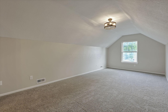 156 E Postal Ave, Newark, OH 43055 - bonus room with vaulted ceiling, carpet floors, and a textured ceiling