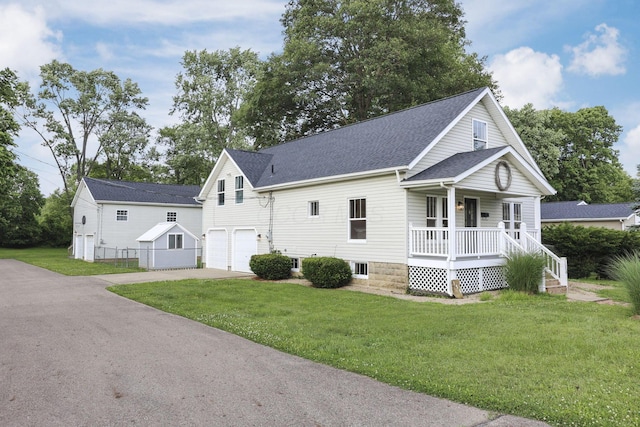 156 E Postal Ave, Newark, OH 43055 - view of front of home featuring covered porch, a garage, driveway, and a front lawn