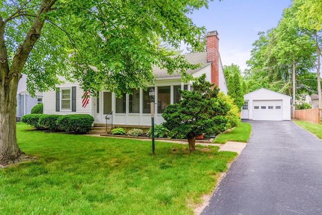 2222 Harwitch Rd, Columbus, OH 43221 - view of property hidden behind natural elements featuring a garage, an outbuilding, a chimney, driveway, and a front yard