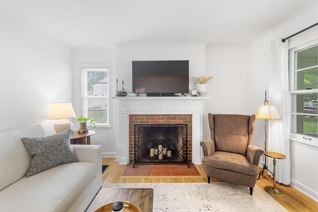 2222 Harwitch Rd, Columbus, OH 43221 - living room featuring wood finished floors, ornamental molding, and a brick fireplace