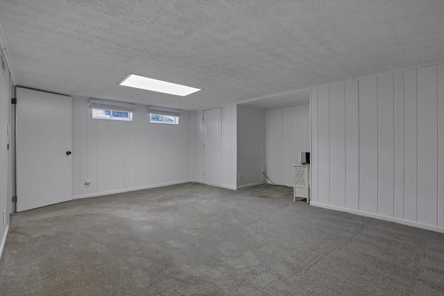 5252 Roche Pl, Columbus, OH 43229 - basement featuring a textured ceiling, carpet floors, and wood walls