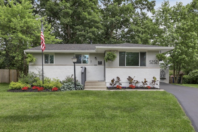 5252 Roche Pl, Columbus, OH 43229 - view of front of house with brick siding, asphalt driveway, and a shingled roof