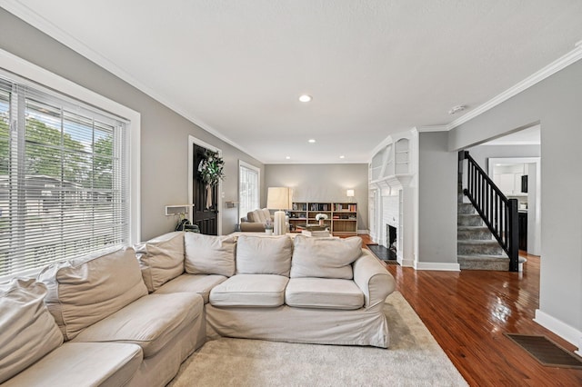 2361 Middlesex Rd, Upper Arlington, OH 43220 - living area featuring wood finished floors, a fireplace, recessed lighting, ornamental molding, and stairs