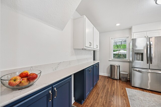 2361 Middlesex Rd, Upper Arlington, OH 43220 - kitchen with stainless steel fridge, blue cabinetry, a textured ceiling, white cabinetry, and dark wood-style flooring