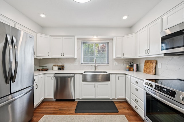 2361 Middlesex Rd, Upper Arlington, OH 43220 - kitchen featuring stainless steel appliances, dark wood-style floors, decorative backsplash, light countertops, and recessed lighting