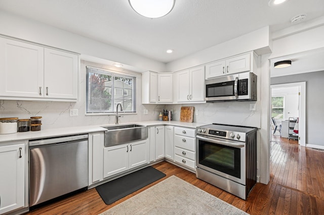 2361 Middlesex Rd, Upper Arlington, OH 43220 - kitchen featuring appliances with stainless steel finishes, healthy amount of natural light, decorative backsplash, dark wood-style flooring, and recessed lighting
