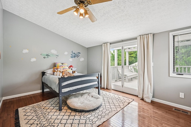 2361 Middlesex Rd, Upper Arlington, OH 43220 - bedroom with access to outside, a textured ceiling, multiple windows, wood-type flooring, and lofted ceiling