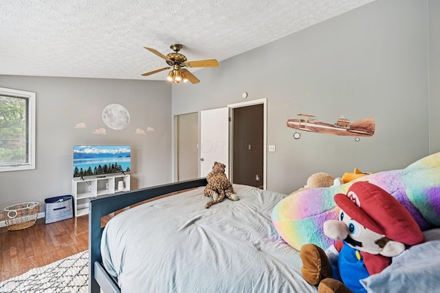 2361 Middlesex Rd, Upper Arlington, OH 43220 - bedroom with hardwood / wood-style flooring, a textured ceiling, lofted ceiling, and ceiling fan