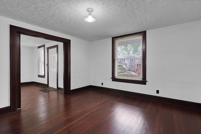 629 E Chestnut St, Lancaster, OH 43130 - spare room featuring dark wood-type flooring and a textured ceiling