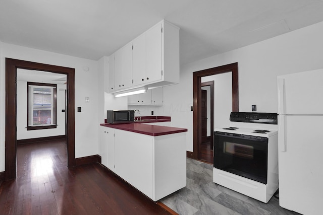629 E Chestnut St, Lancaster, OH 43130 - kitchen featuring freestanding refrigerator, range with electric stovetop, black microwave, white cabinets, and dark countertops