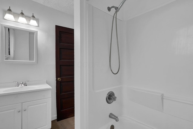 629 E Chestnut St, Lancaster, OH 43130 - bathroom with bathtub / shower combination, vanity, tile patterned flooring, and a textured ceiling