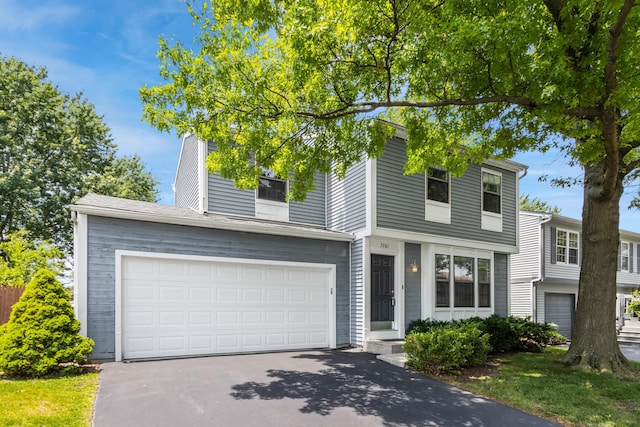7701 Kelvinway Dr Unit 74, Columbus, OH 43085 - traditional-style home featuring asphalt driveway and an attached garage