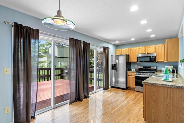 7701 Kelvinway Dr Unit 74, Columbus, OH 43085 - kitchen with stainless steel appliances, light wood-style floors, recessed lighting, and hanging light fixtures