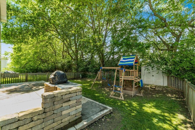 4867 Fosterson Dr, Lockbourne, OH 43137 - fenced backyard with a playground, a storage shed, and a patio area