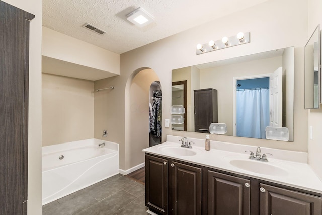 4867 Fosterson Dr, Lockbourne, OH 43137 - bathroom with double vanity, a garden tub, and tile patterned flooring