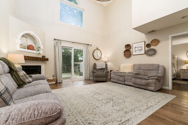 4867 Fosterson Dr, Lockbourne, OH 43137 - living area featuring wood finished floors, a fireplace, and a high ceiling