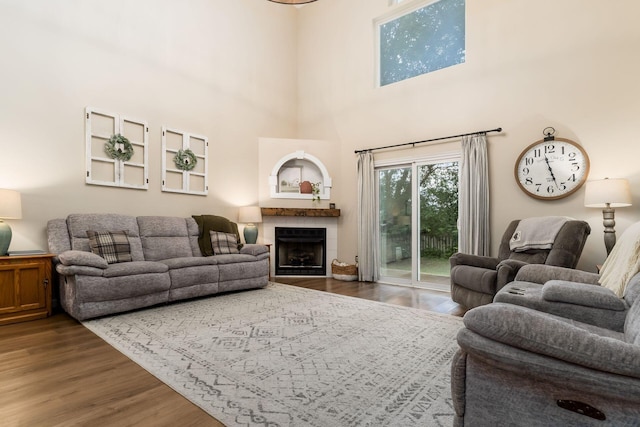 4867 Fosterson Dr, Lockbourne, OH 43137 - living area with wood finished floors, a tiled fireplace, and a high ceiling