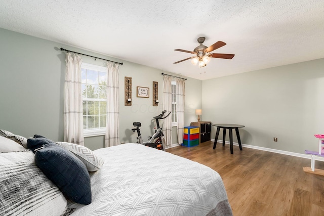 4867 Fosterson Dr, Lockbourne, OH 43137 - bedroom featuring wood finished floors, a textured ceiling, and a ceiling fan