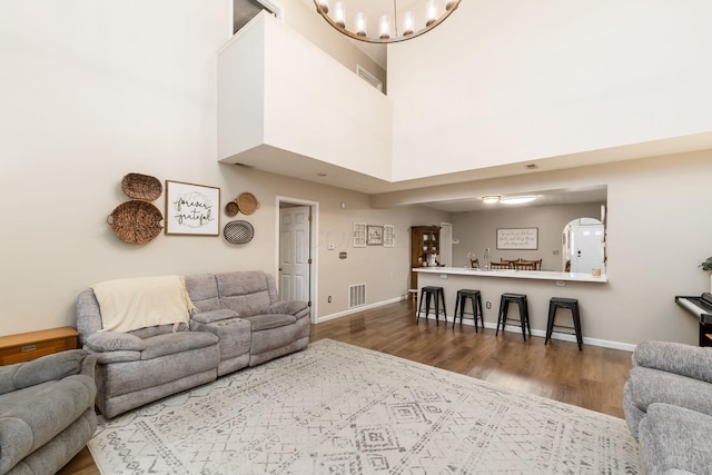 4867 Fosterson Dr, Lockbourne, OH 43137 - living room with wood finished floors, a chandelier, and a high ceiling