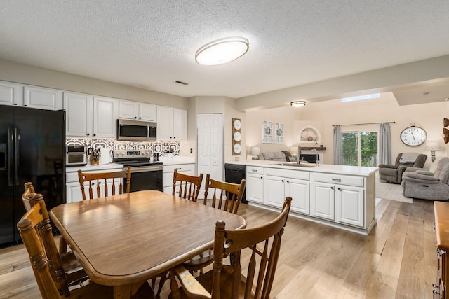 4867 Fosterson Dr, Lockbourne, OH 43137 - dining space featuring light wood-type flooring and a textured ceiling