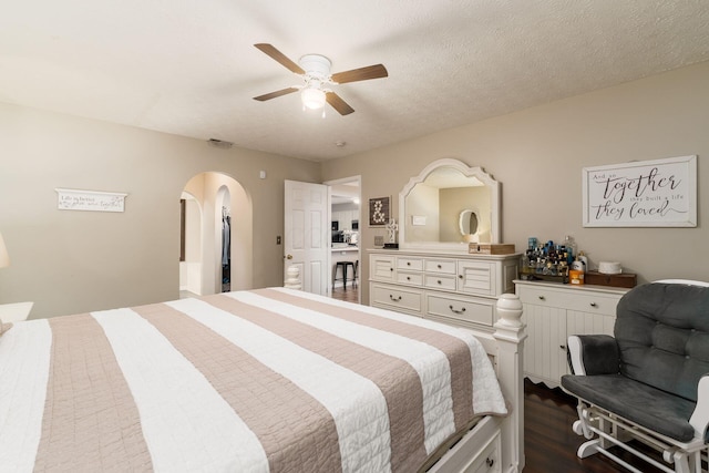 4867 Fosterson Dr, Lockbourne, OH 43137 - bedroom with arched walkways, dark wood-style flooring, and a ceiling fan