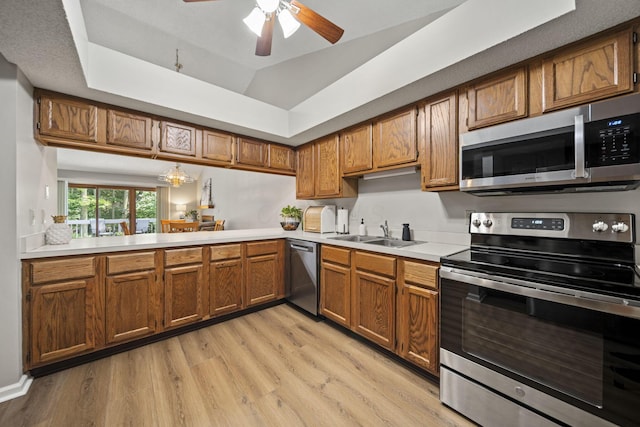 7982 Lewis Ave Unit 21, Dublin, OH 43017 - kitchen with appliances with stainless steel finishes, brown cabinets, light countertops, light wood finished floors, and ceiling fan