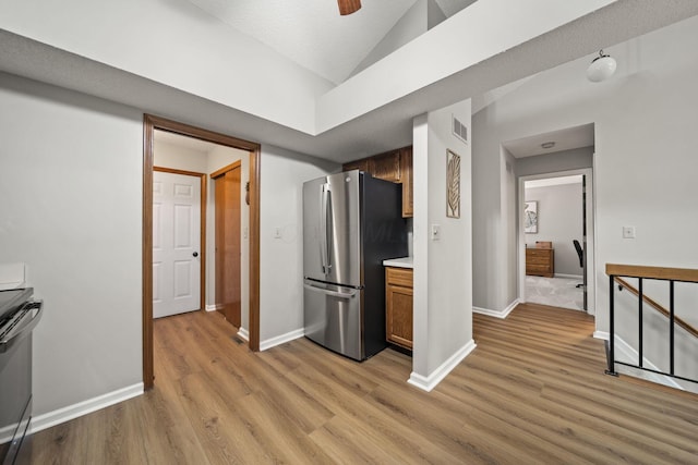 7982 Lewis Ave Unit 21, Dublin, OH 43017 - kitchen featuring appliances with stainless steel finishes, light wood finished floors, lofted ceiling, a ceiling fan, and light countertops