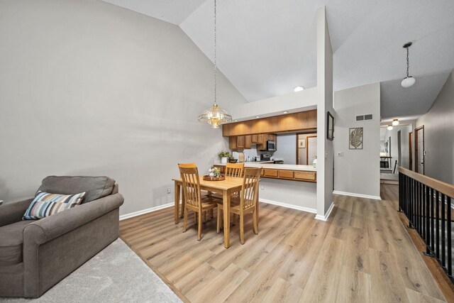 7982 Lewis Ave Unit 21, Dublin, OH 43017 - dining space featuring light wood finished floors, high vaulted ceiling, and recessed lighting