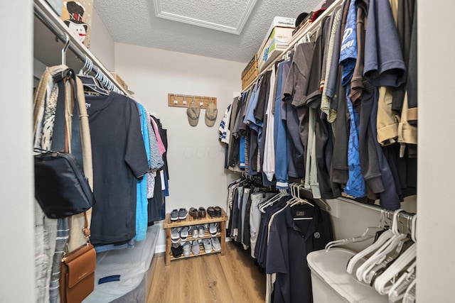 7982 Lewis Ave Unit 21, Dublin, OH 43017 - walk in closet featuring attic access and wood finished floors