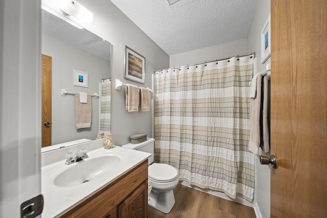 7982 Lewis Ave Unit 21, Dublin, OH 43017 - bathroom with vanity, a textured ceiling, wood finished floors, and curtained shower