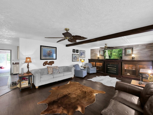 800 Spring Rd S, Westerville, OH 43081 - living room featuring a textured ceiling, ceiling fan, wood finished floors, a fireplace, and beamed ceiling