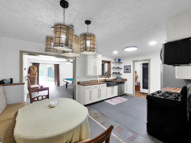 800 Spring Rd S, Westerville, OH 43081 - kitchen featuring dishwasher, gas stove, a ceiling fan, a textured ceiling, and white cabinetry