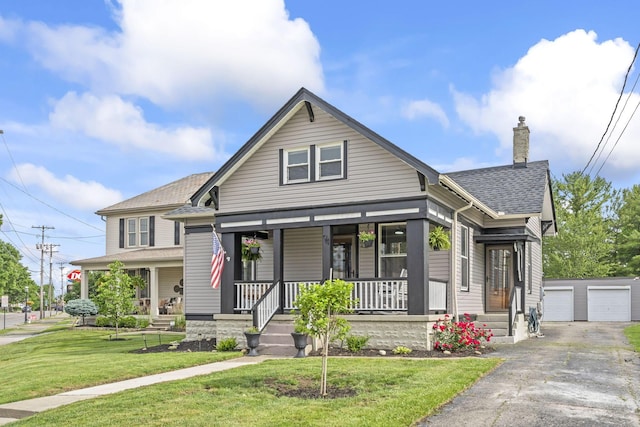 94 W Waterloo St, Canal Winchester, OH 43110 - view of front of house featuring covered porch, an outbuilding, a front lawn, a chimney, and a shingled roof