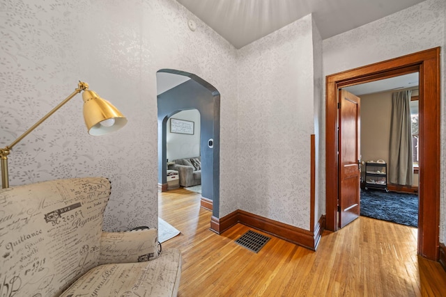94 W Waterloo St, Canal Winchester, OH 43110 - hallway with hardwood / wood-style flooring, arched walkways, and wallpapered walls