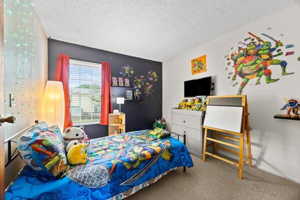 5153 Singleton Dr Unit 44B, Hilliard, OH 43026 - bedroom with a textured ceiling and carpet floors