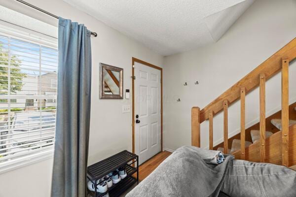 5153 Singleton Dr Unit 44B, Hilliard, OH 43026 - foyer with stairway, wood finished floors, and a textured ceiling