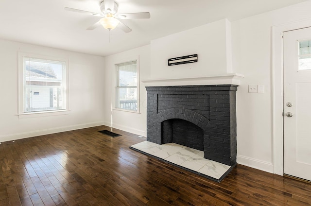 786 Ann St, Columbus, OH 43206 - unfurnished living room featuring wood finished floors, ceiling fan, and a brick fireplace