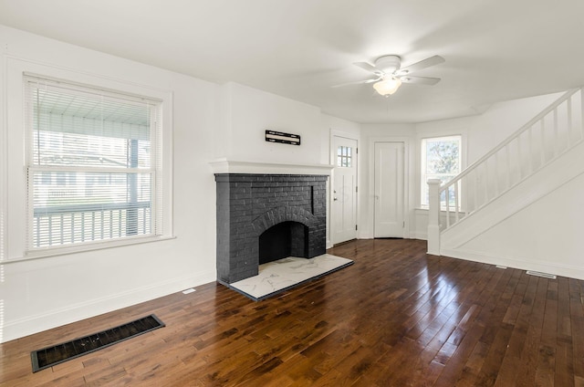 786 Ann St, Columbus, OH 43206 - unfurnished living room featuring a ceiling fan, wood finished floors, stairs, and a brick fireplace