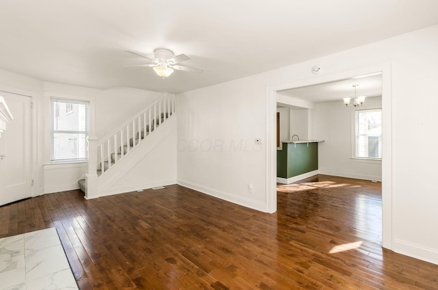 786 Ann St, Columbus, OH 43206 - spare room with stairway, hardwood / wood-style floors, a chandelier, and a ceiling fan