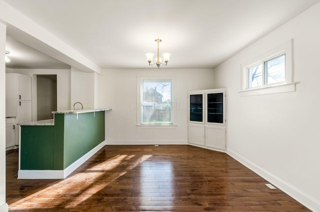 786 Ann St, Columbus, OH 43206 - unfurnished dining area with healthy amount of natural light, a chandelier, and dark wood-style floors